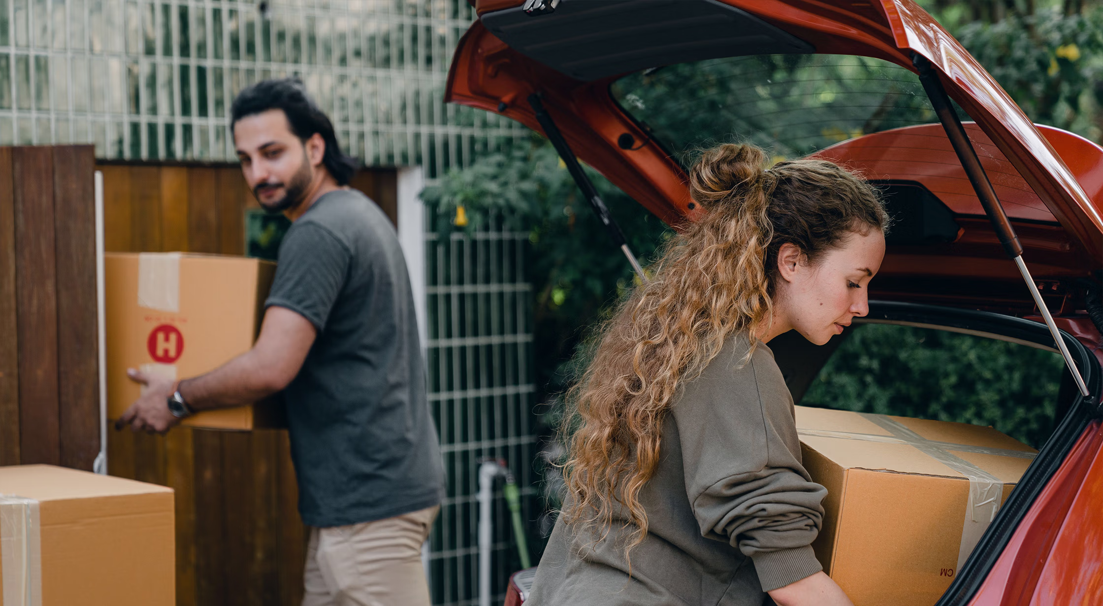 Homeowners packing boxes before selling their San Antonio house